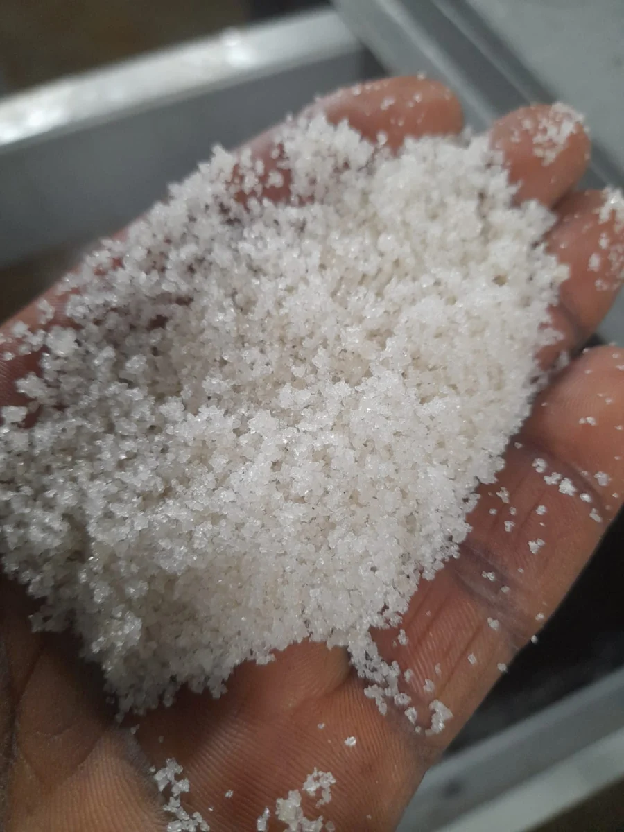 A sample of sugar crystals held in a hand