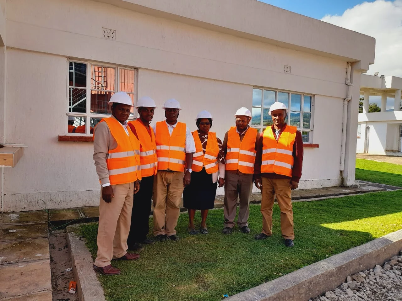 Ranges Sugar staff wearing protective helmets and safety vests at the factory site